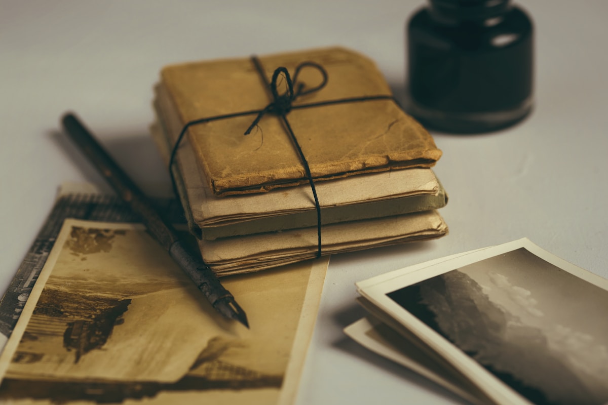A vintage book open to mathematical formulas and a pair of glasses